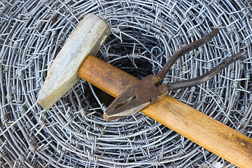 Image showing Barbed wire, a hammer and pliers