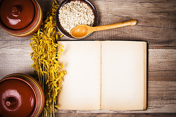 Image showing Oatmeal and an old recipe book on the kitchen table 