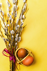 Image showing bunch of willow branches and two Easter eggs in basket 