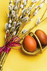 Image showing bunch of willow branches and two Easter eggs in basket 