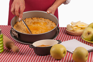 Image showing Spreading marmalade on apple pie dough