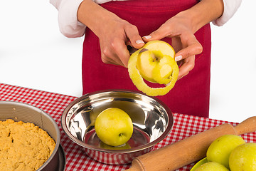 Image showing Peeling apples