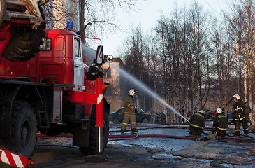 Image showing Firefighters extinguish a fire