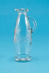 Image showing old glass jug jar pitcher handle on blue 