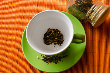 Image showing afternoon green tea cup with on orange mat