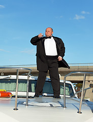 Image showing Fat man in tuxedo with glass wine