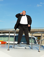 Image showing Fat man in tuxedo with glass wine