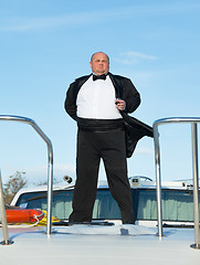 Image showing Fat man in tuxedo with glass wine