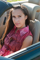 Image showing Beautiful brunette woman sitting in the car