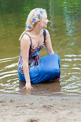 Image showing Shot of beautiful woman sitting in the pond