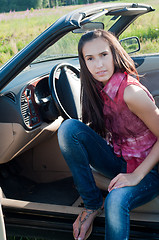 Image showing Beautiful brunette woman sitting in the car