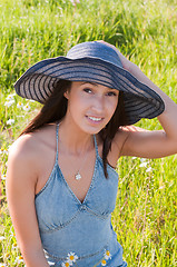 Image showing Beautiful brunette woman in big denim hat