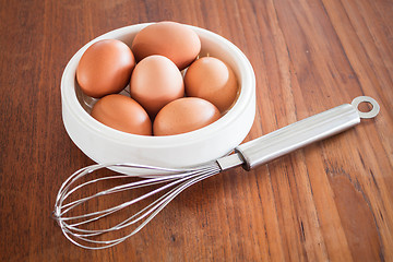 Image showing Fresh chicken eggs and hand mixer for beating