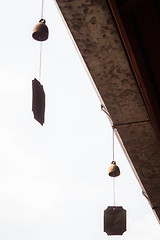 Image showing Small wind bell hang on eaves with white background  