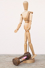 Image showing Wood mannequin and hourglass to represent unfortunately time