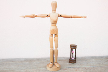 Image showing Wooden mannequin extend the arms of count down 