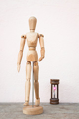 Image showing Wooden mannequin pose in concept of progress time  