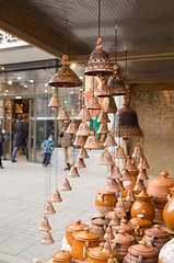 Image showing clay pots hang bells ware store shop market people 