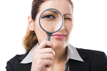 Image showing Business holding a magnifying glass