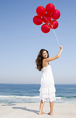 Image showing Beautiful girl holding red ballons
