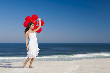 Image showing Beautiful girl holding red ballons