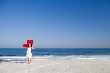 Image showing Beautiful girl holding red ballons