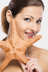 Image showing Beautiful woman holding a starfish