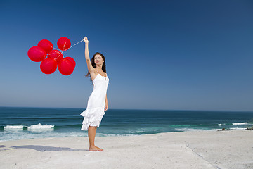 Image showing Beautiful girl holding red ballons