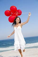 Image showing Beautiful girl holding red ballons