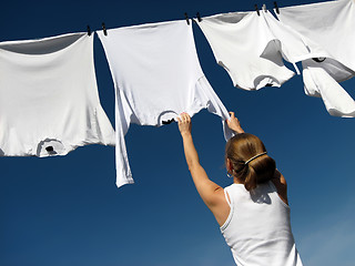 Image showing Girl, blue sky and white laundry