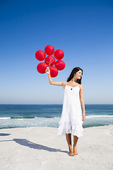 Image showing Beautiful girl holding red ballons