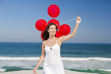 Image showing Beautiful girl holding red ballons