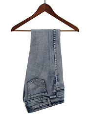 Image showing Jeans on a wooden hanger