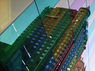 Image showing Building reflections in colourful glass windows