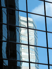Image showing Corporate tower reflecting another office building and the sky