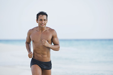 Image showing Man running on the beach