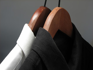 Image showing Black and white shirts on wooden hangers