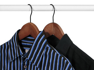 Image showing Black and blue shirts on a rack