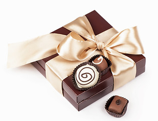 Image showing brown box with candies and golden tape