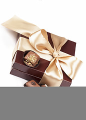 Image showing brown box with candies and golden tape