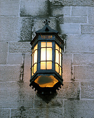 Image showing Vintage lantern on a stone wall of an old building