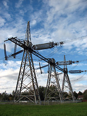 Image showing High voltage electricity pylons near the houses