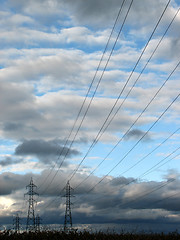 Image showing Power lines and electricity pylons in a field