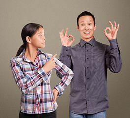 Image showing Asian Man and Girl Showing OK