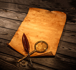 Image showing Blank old paper against the background of an aged wood