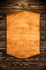 Image showing Blank old paper against the background of an aged wood