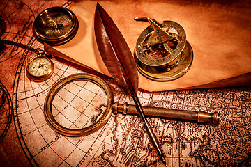 Image showing Vintage magnifying glass lies on an ancient world map