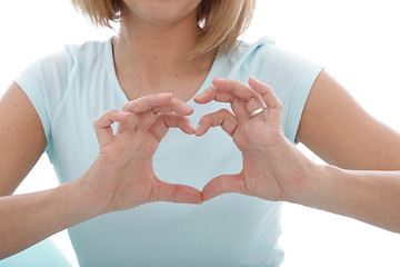 Image showing Woman making a heart gesture with her fingers