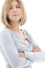 Image showing Thoughtful woman standing with folded arms