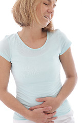 Image showing Woman holding her stomach in pain